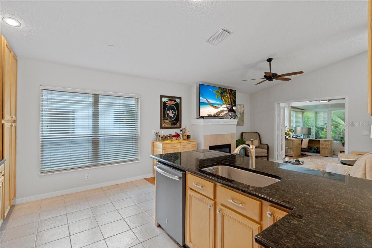Open concept kitchen is well -equipped with stainless steel appliances, ceramic tile floors, and breakfast bar