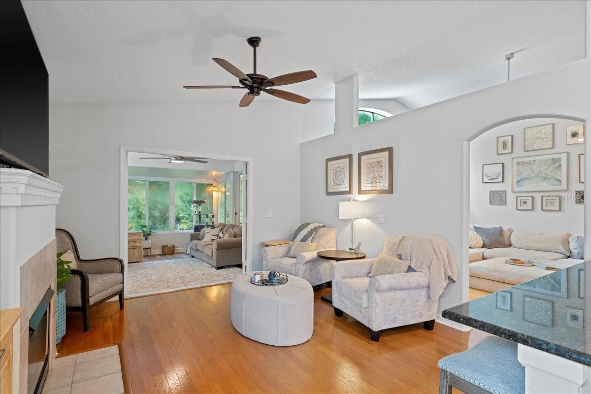 Family room with cozy fireplace and French doors to the Florida room/ sunroom.