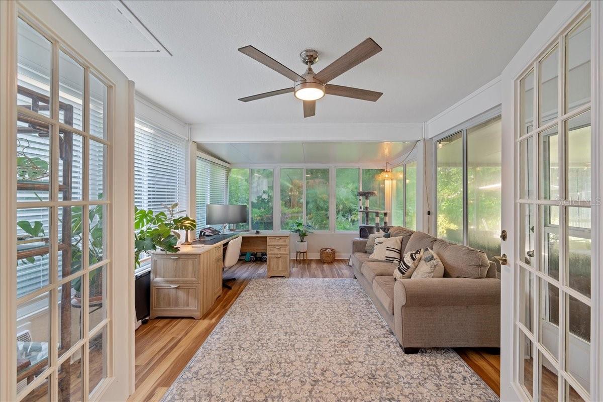 French doors off the family room welcome you to the amazing window filled Florida room with AC and access to the patio.