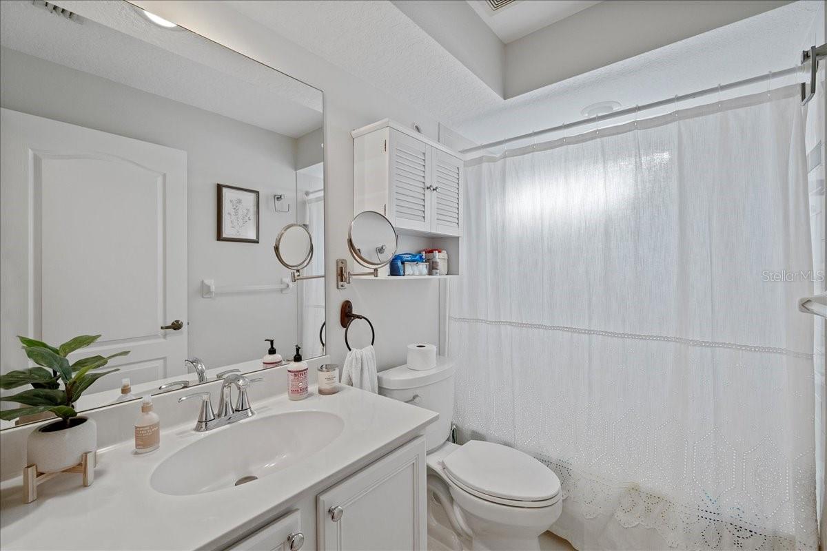 Second bathroom located off foyer shared by 2nd and 3rd bedrooms