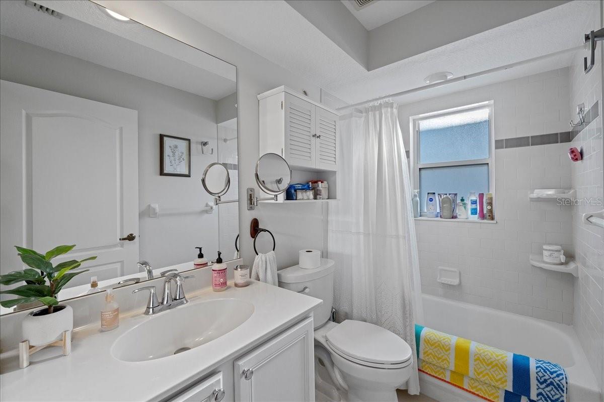 White and bright second bathroom with shower/tub combo and linen closet just across the hall.