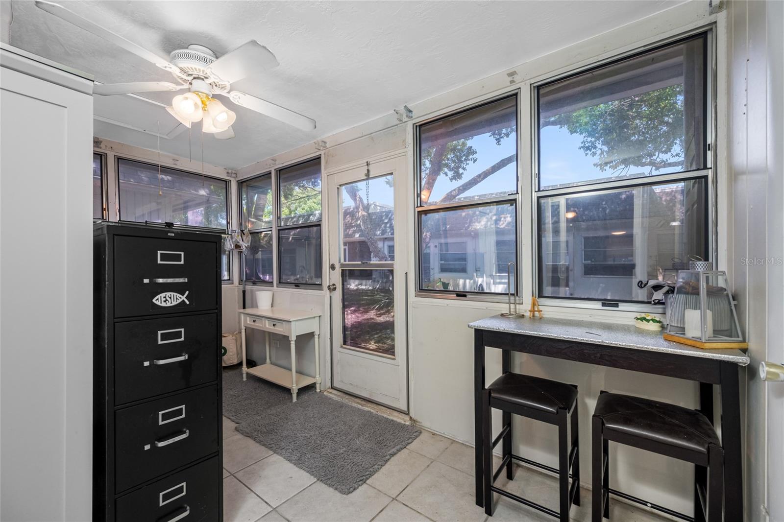 Flex space leading to back yard doubles as private inside laundry with large wash sink and storage closet.