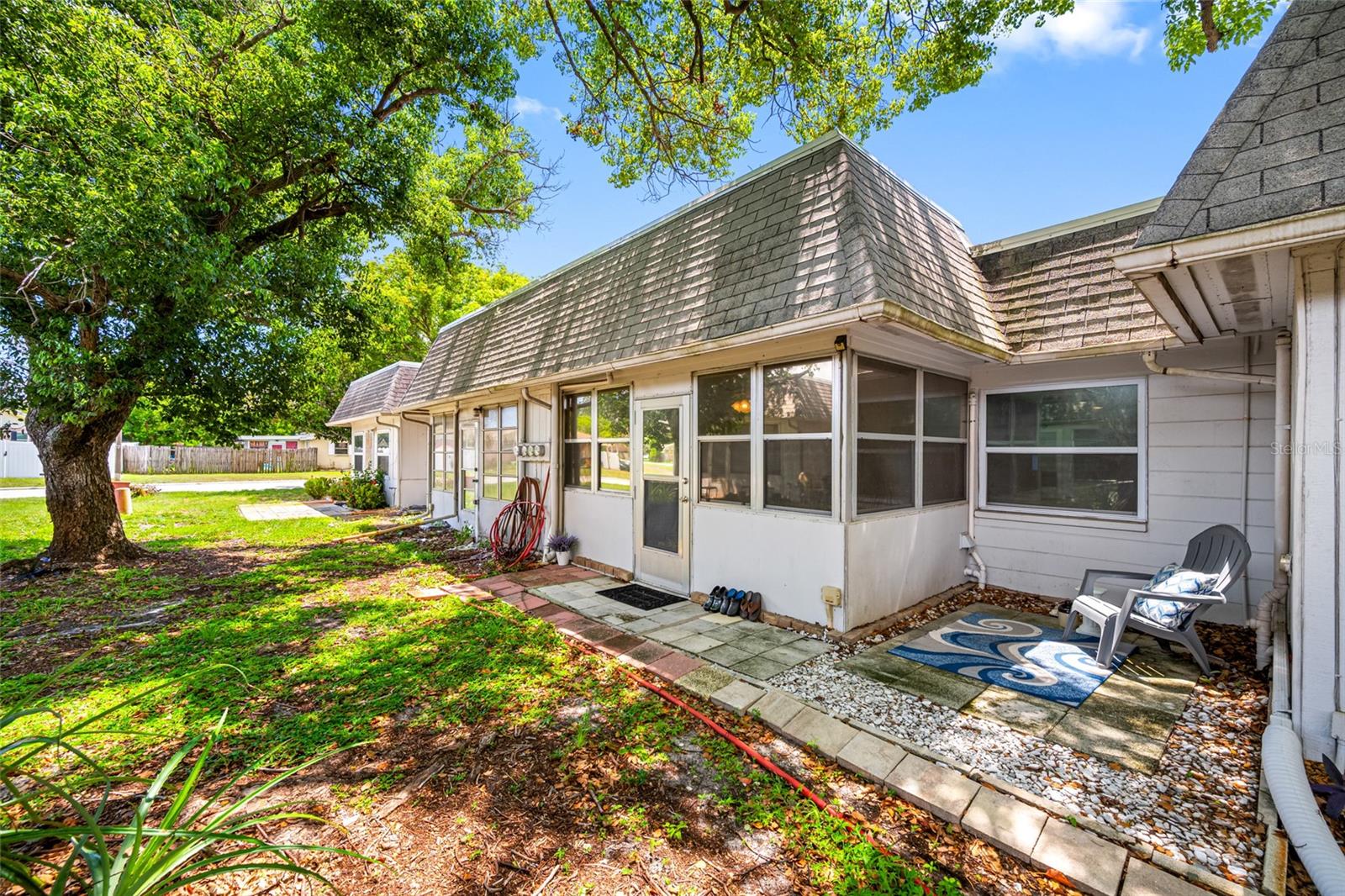 Back of unit has lots of natural shade and an outdoor patio area.