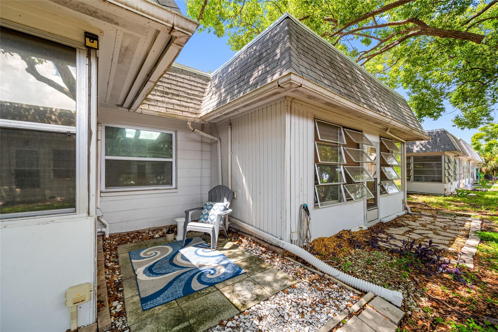 Back of unit has lots of natural shade and an outdoor patio area.