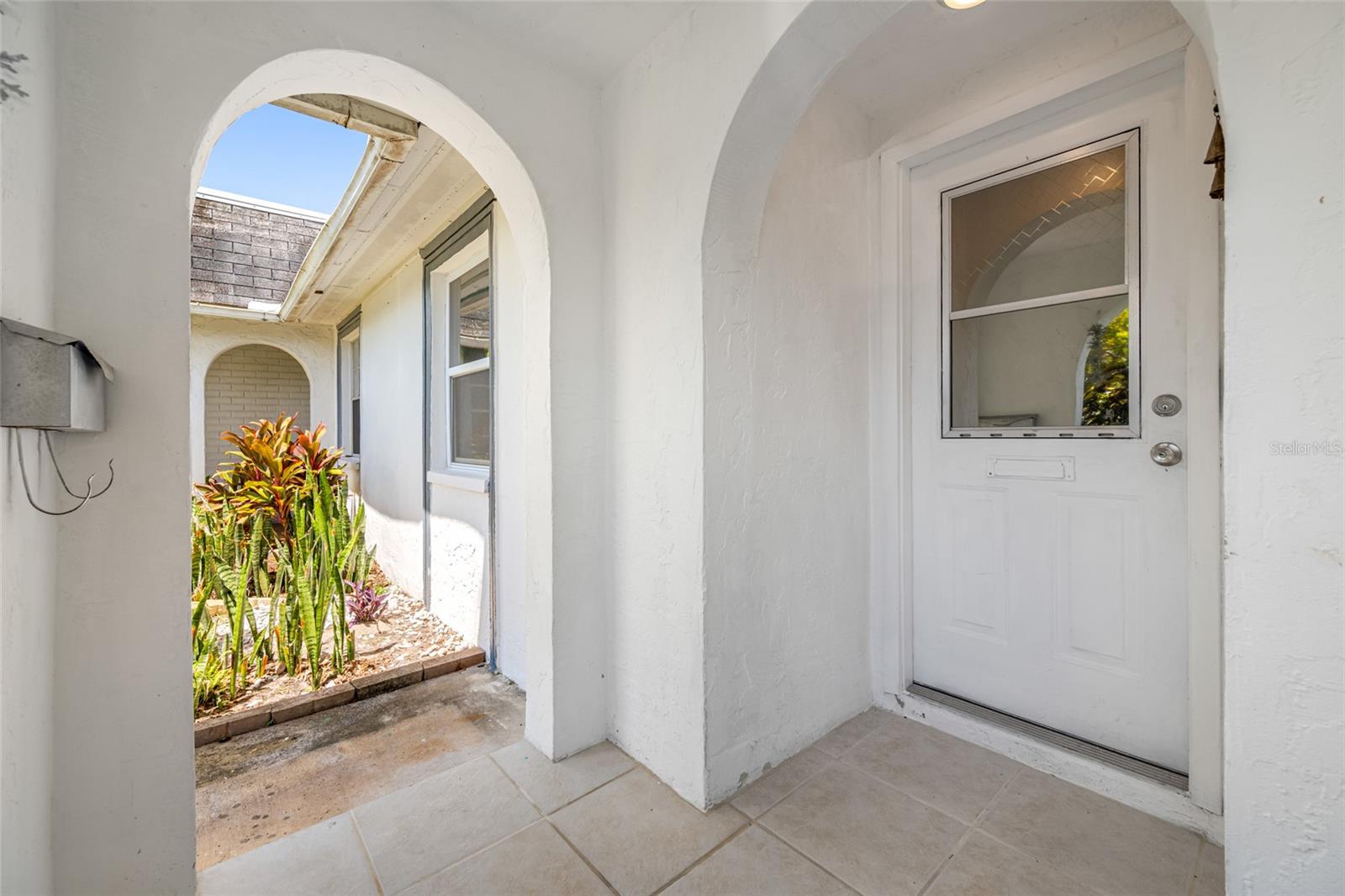 Semi private covered entrance features updated tile!