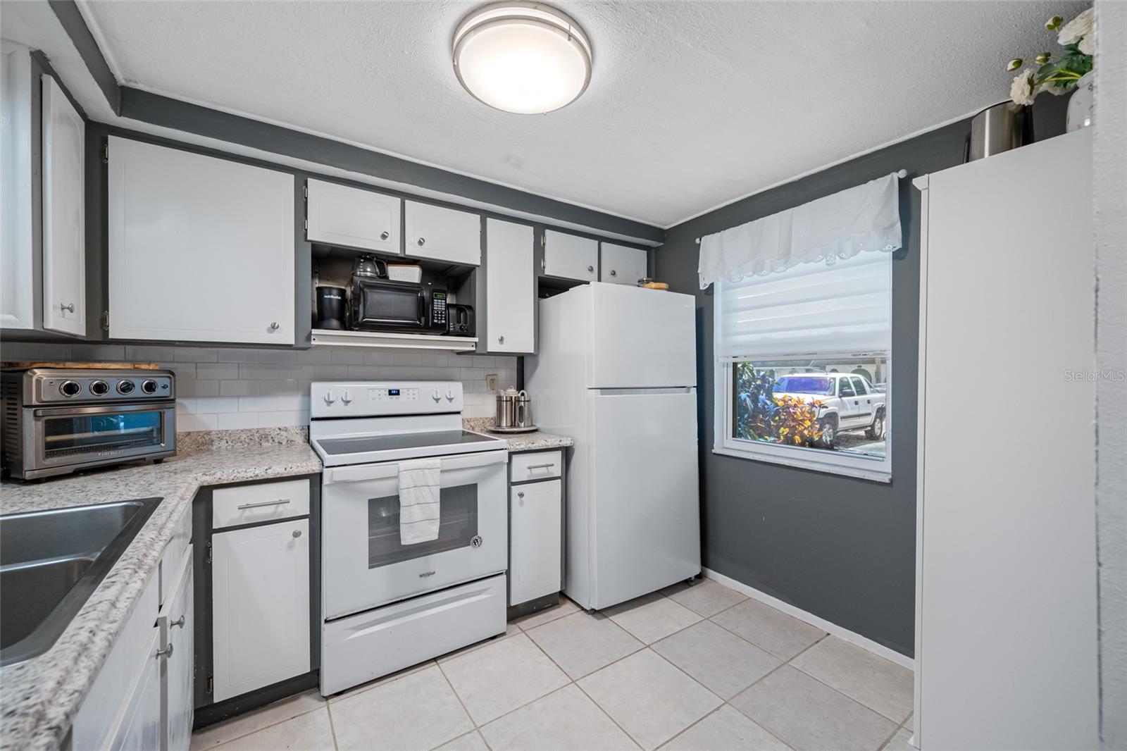 Light and bright kitchen has enough space to cook up a fantastic meal! Also has updated window!!!