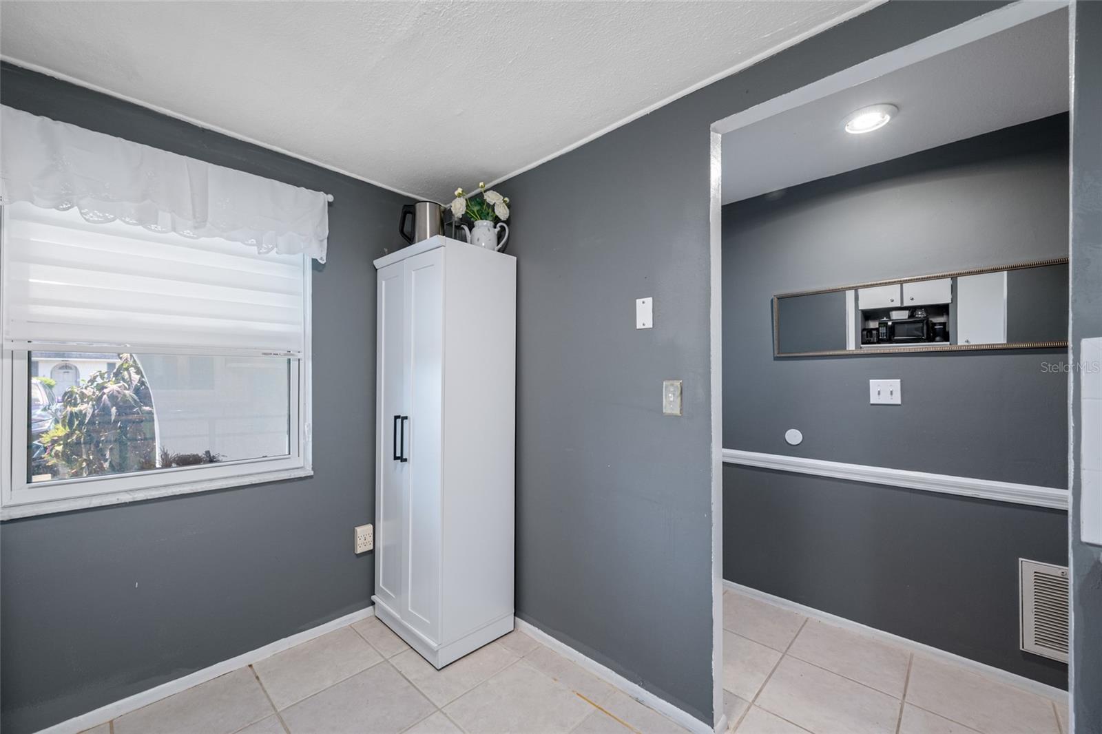 Kitchen nook has space for a small table or additional pantry storage.
