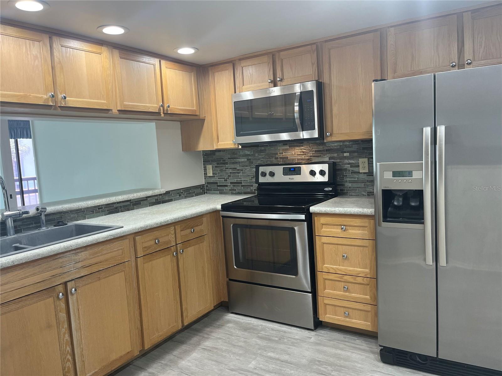 stainless steel appliances, including dishwasher and plenty of cupboards