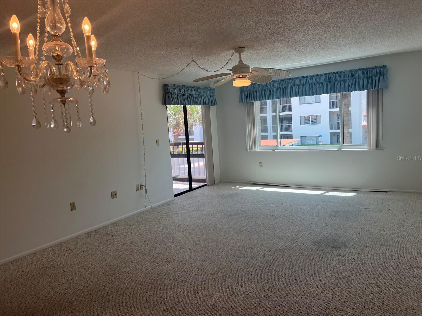 View from dining room across living room in sliders to one of two screened Lanais