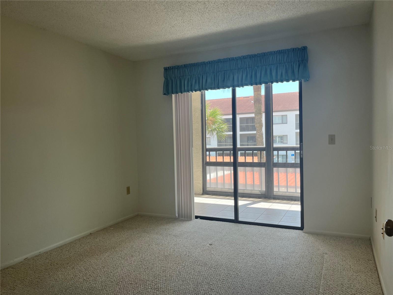 Second bedroom view of its own balcony also with vinyl sliders that pull up to the ceiling for inclement weather