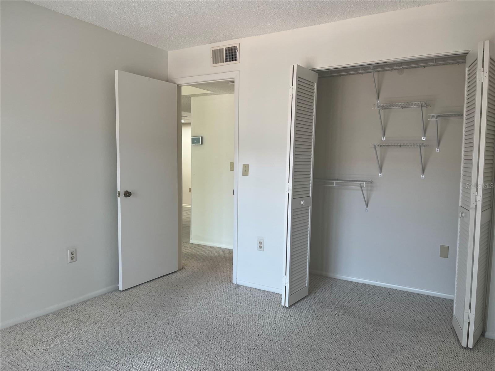 View from second bedroom, sliders, looking back into large closet