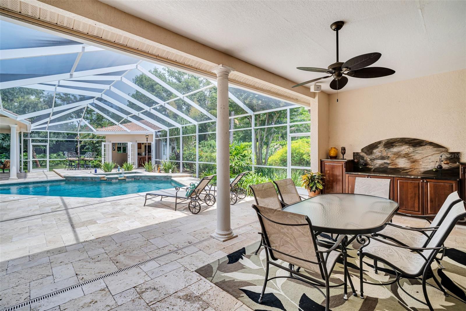 Large Covered Patio area with lovely matching to the Kitchen cabinetry...