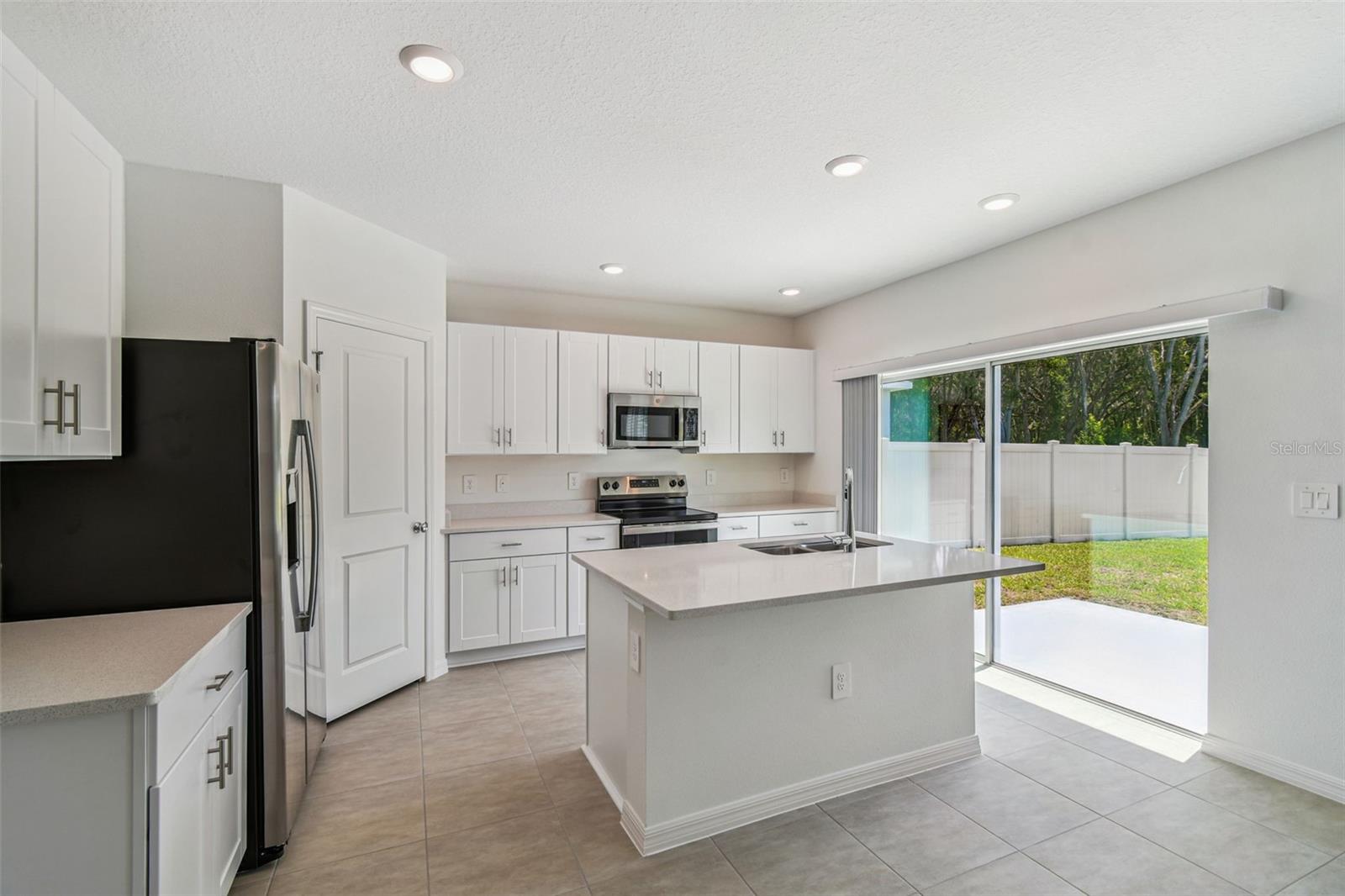 Kitchen w/Island, Pantry, & Access to Patio