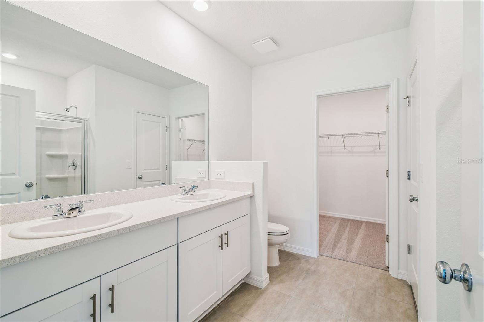 Primary Bathroom w/Double Vanities, Quartz Countertops, & Walk-in Closet