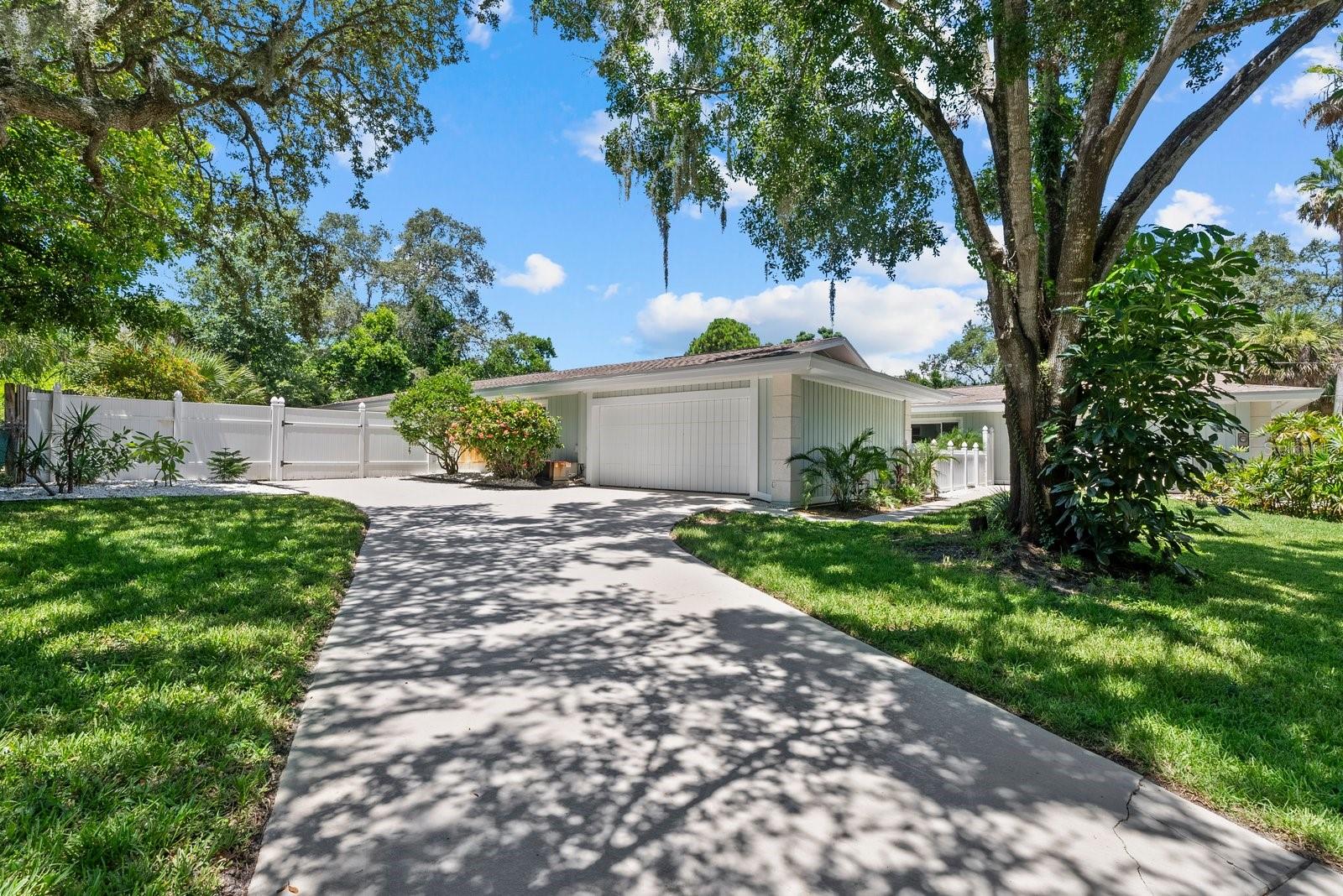 two car garage with it's own driveway on the left side of home