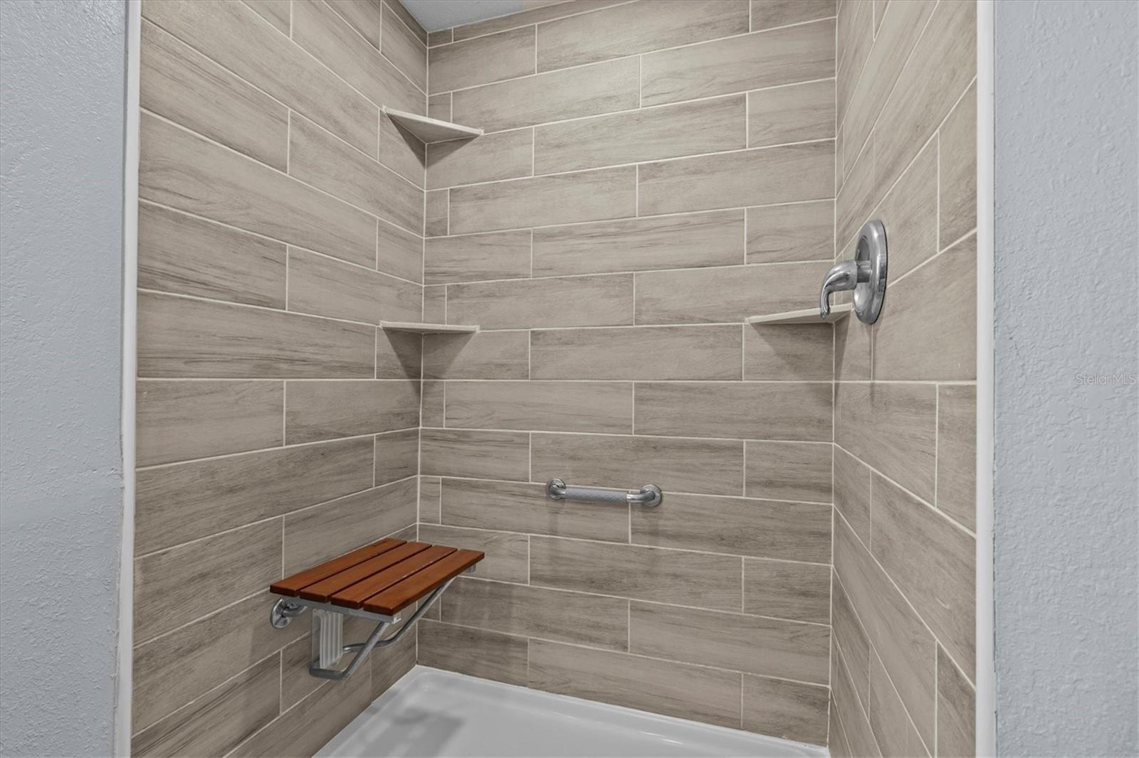 Walk in shower with fold down seat.