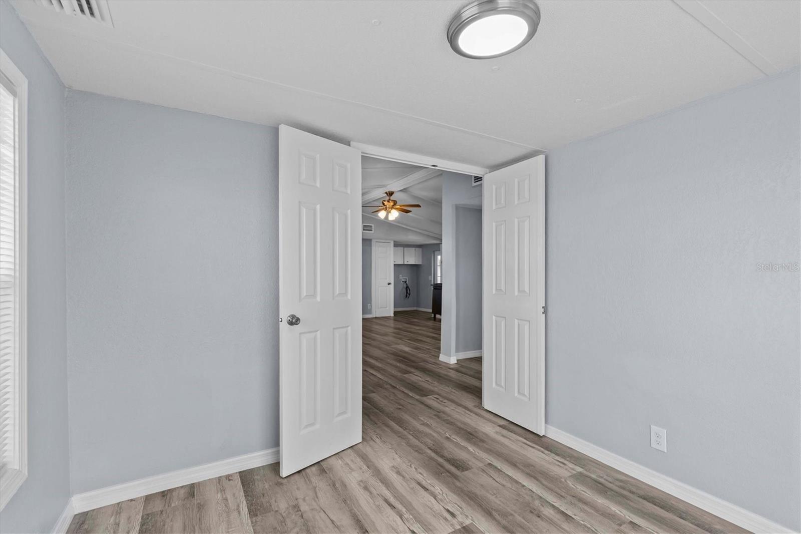 Second bedroom with double doors and a sliding glass door for lots of natural light. This exits onto a large porch area. A 12 x 8 porch.