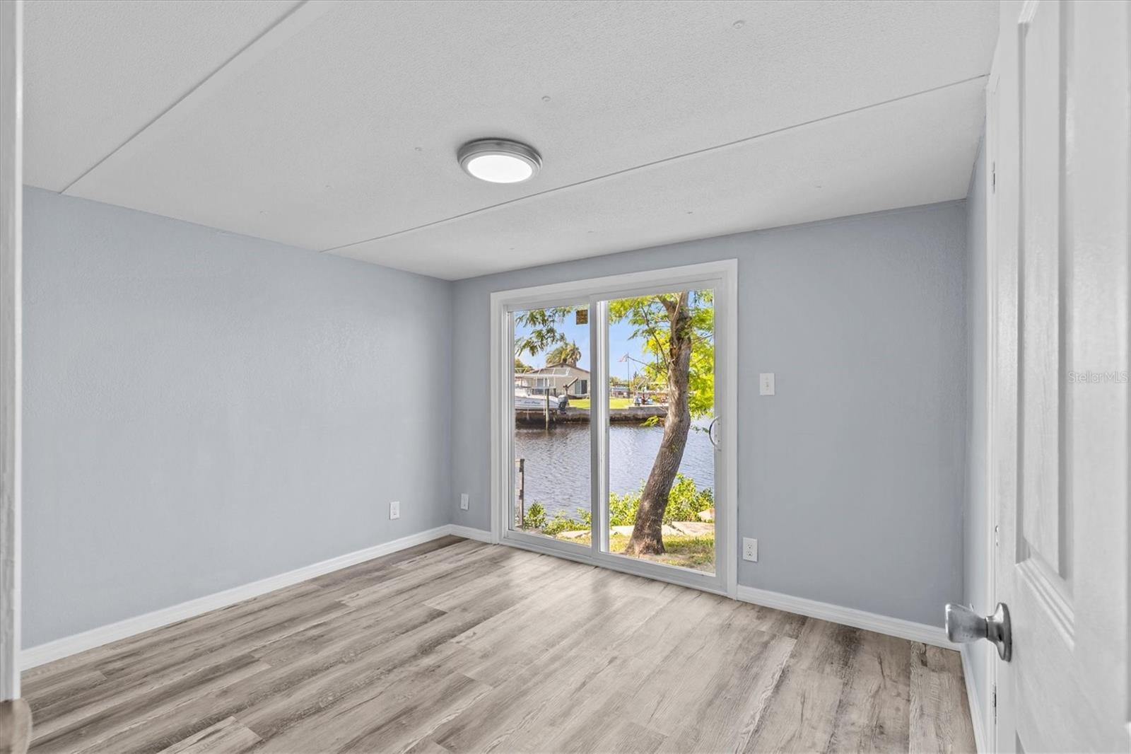 3rd bedroom with a sliding door access to the canal side.