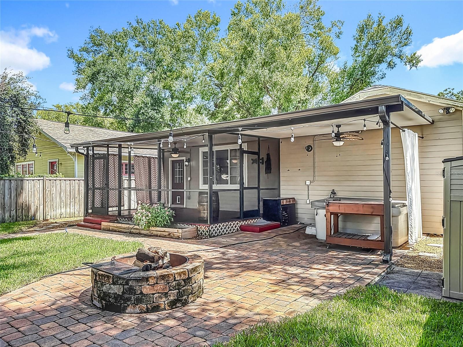 Back Yard w/ view of Hot Tub, Fire Pit, Screened-in Porch