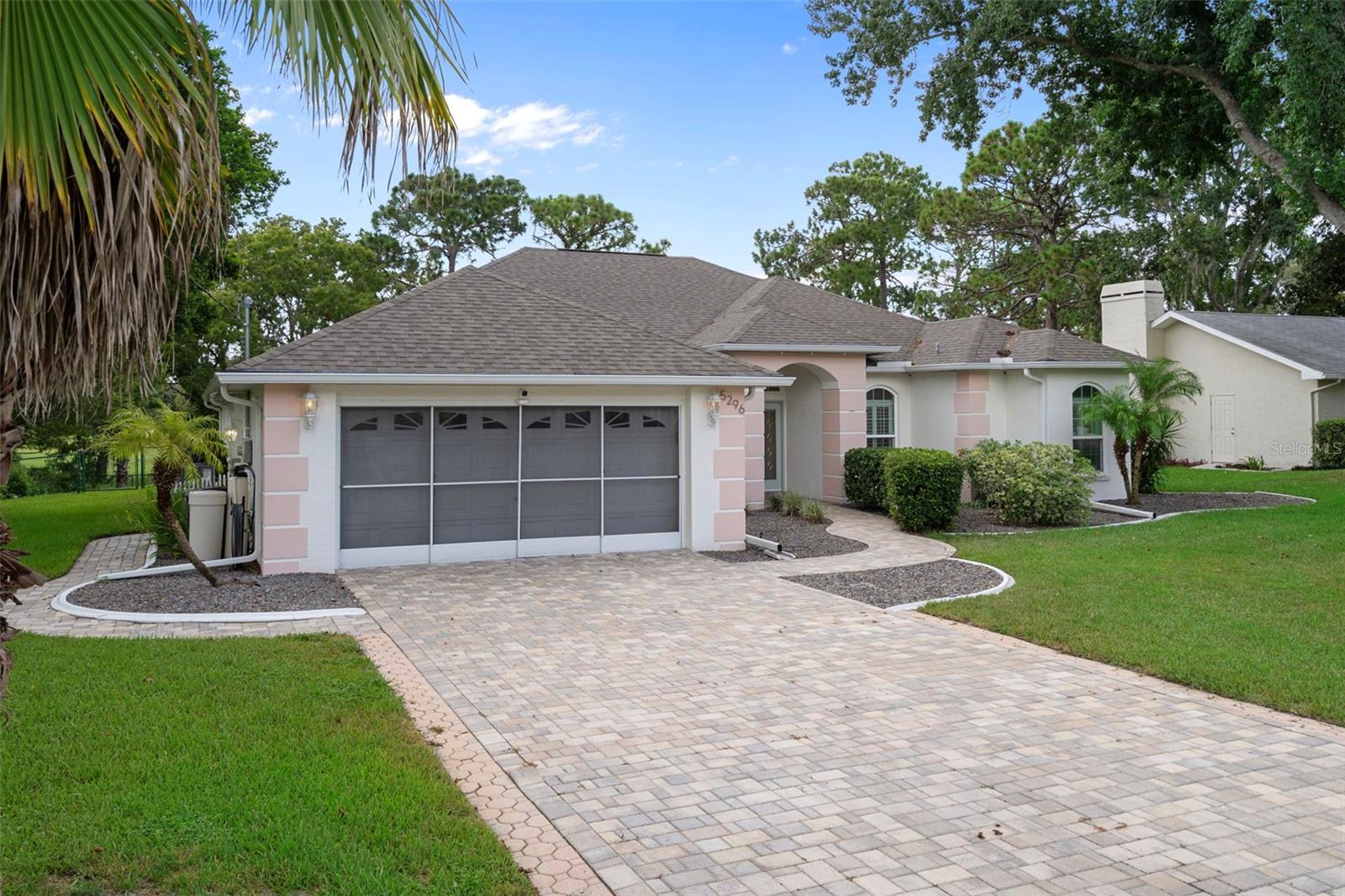 The stylish paver driveway adds the perfect touch to this home.