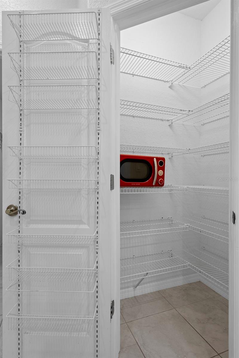 The large walk in pantry has an abundance of shelving for your convenience.