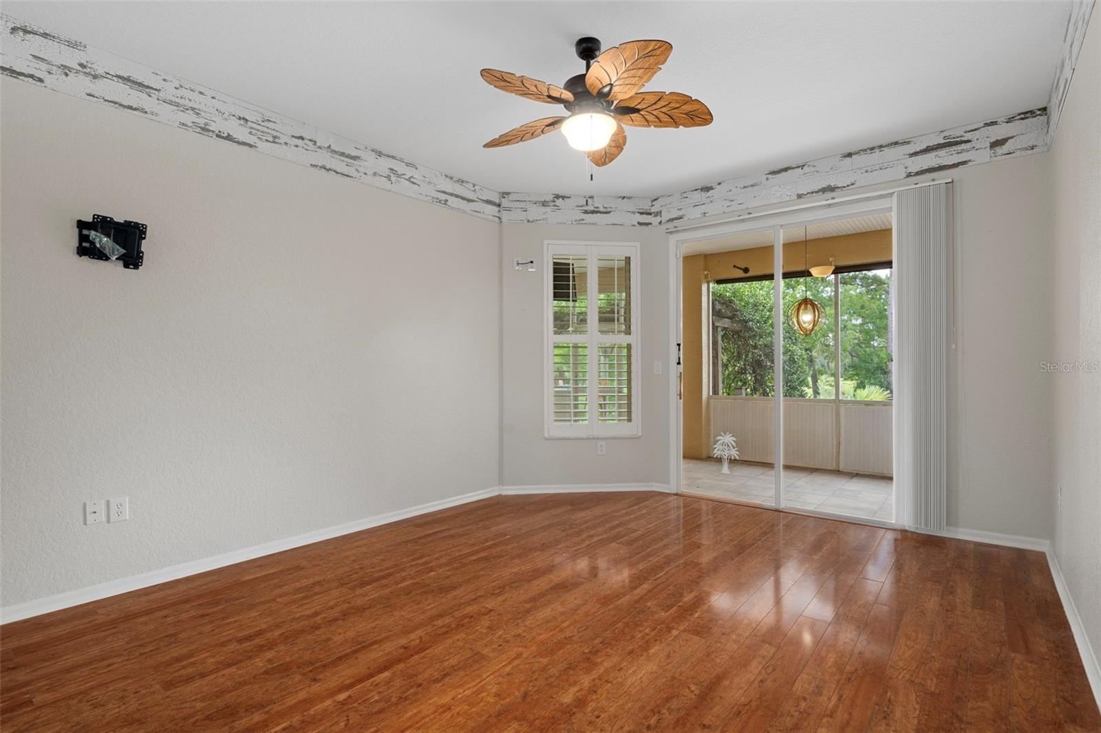 Sliding glass doors give you convenient access to the screened in lanai with tiles.