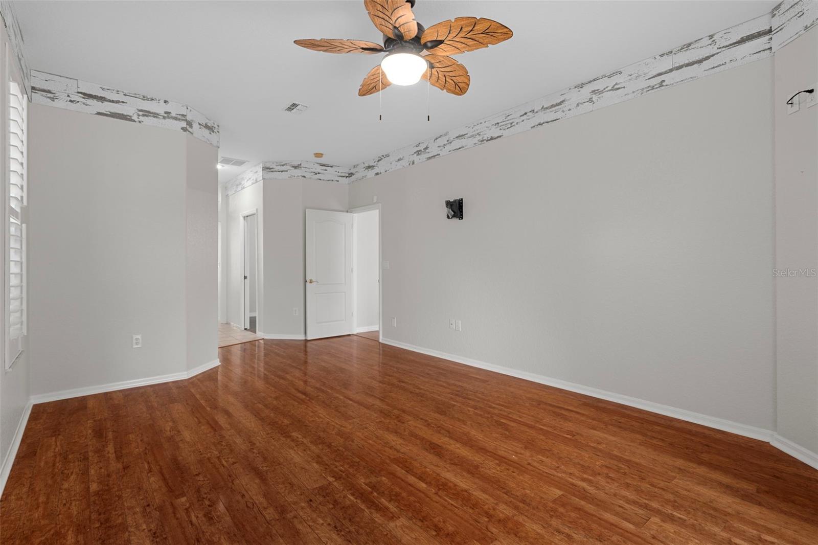 Charming laminate  floors continue into the master  bedroom.