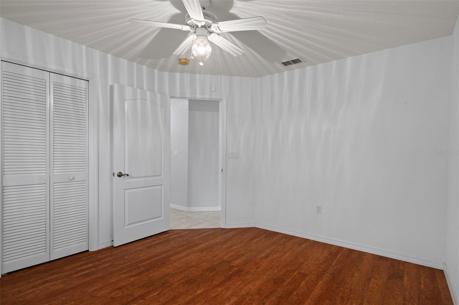 Laminate floors continue into the bedroom.