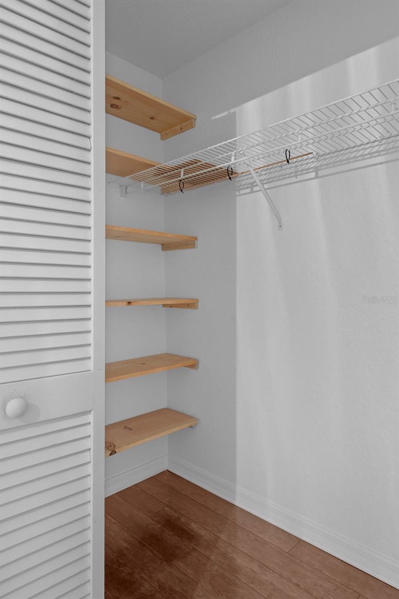 Built in shelving inside the walk in closet.