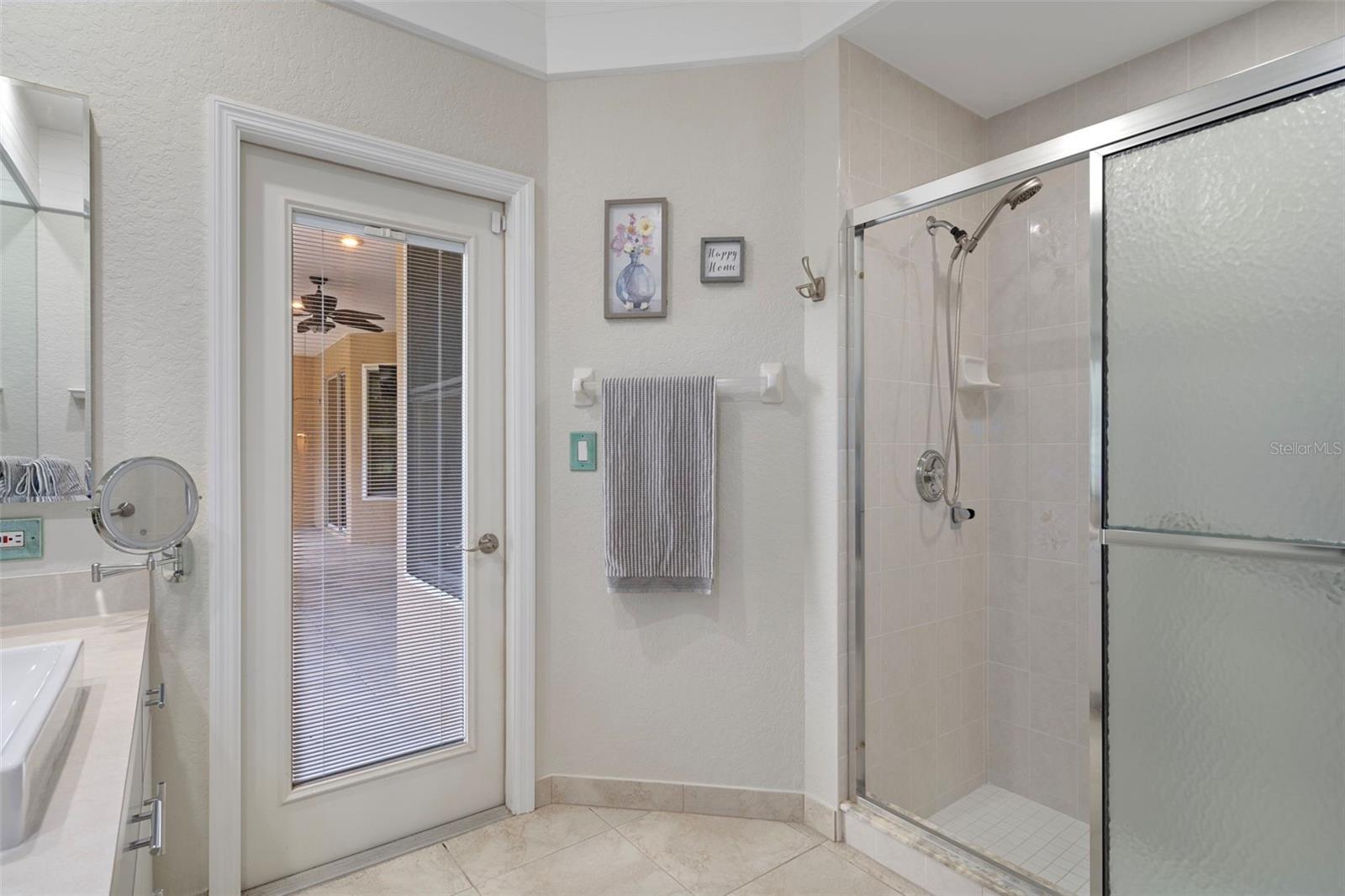 Exterior door inside the guest bath leads right out to the back screened lanai.