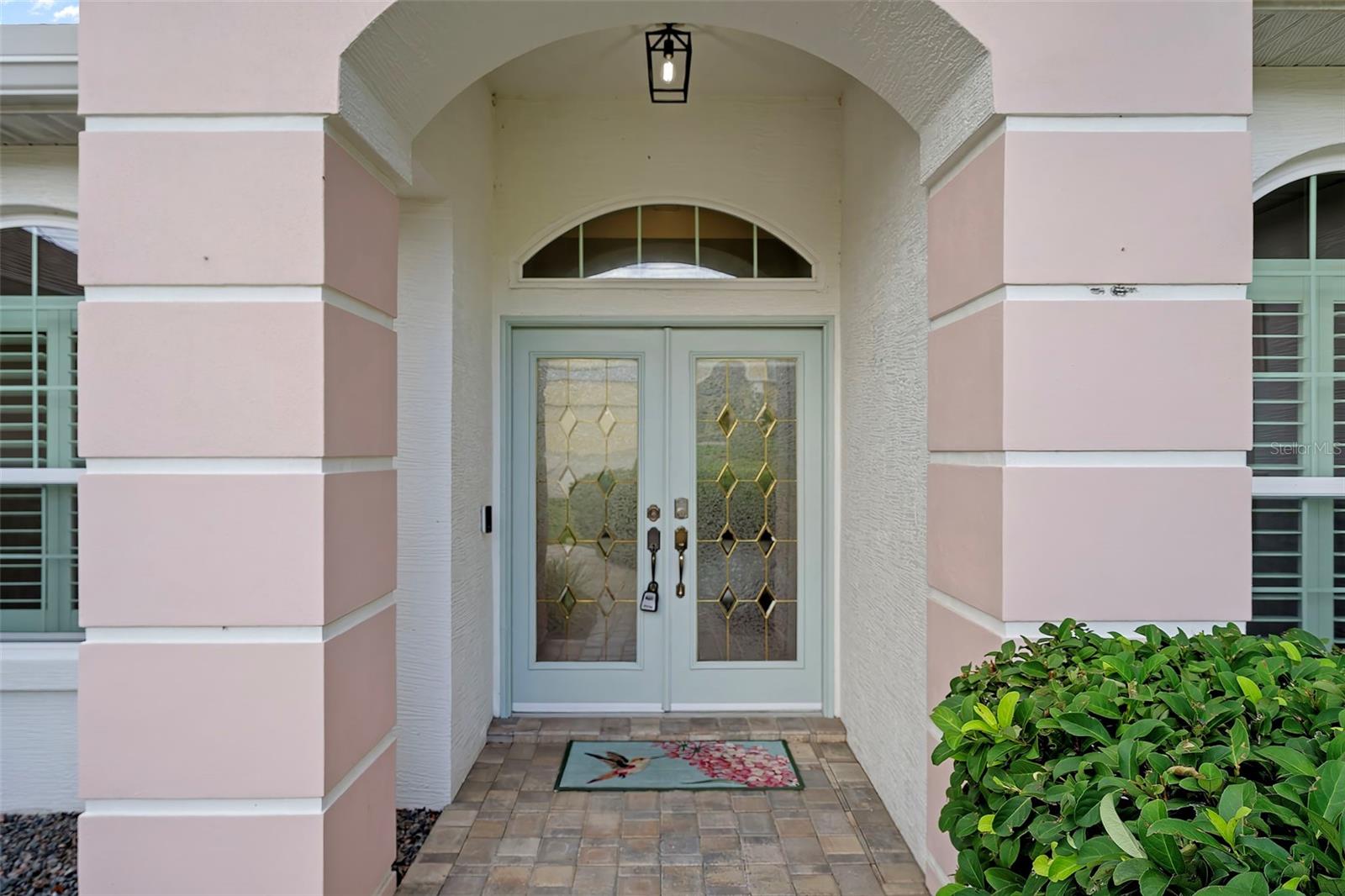 You will love the gorgeous upgraded double door with leaded glass that is covered with a porch light.