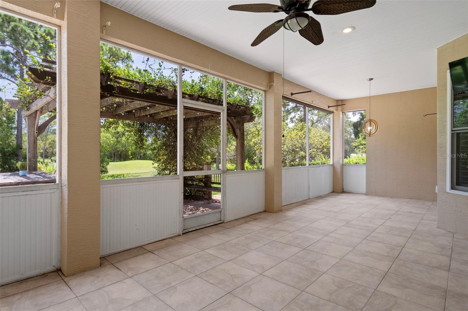 Ceiling fans make this screened in  patio enjoyable in the heat of the summer!