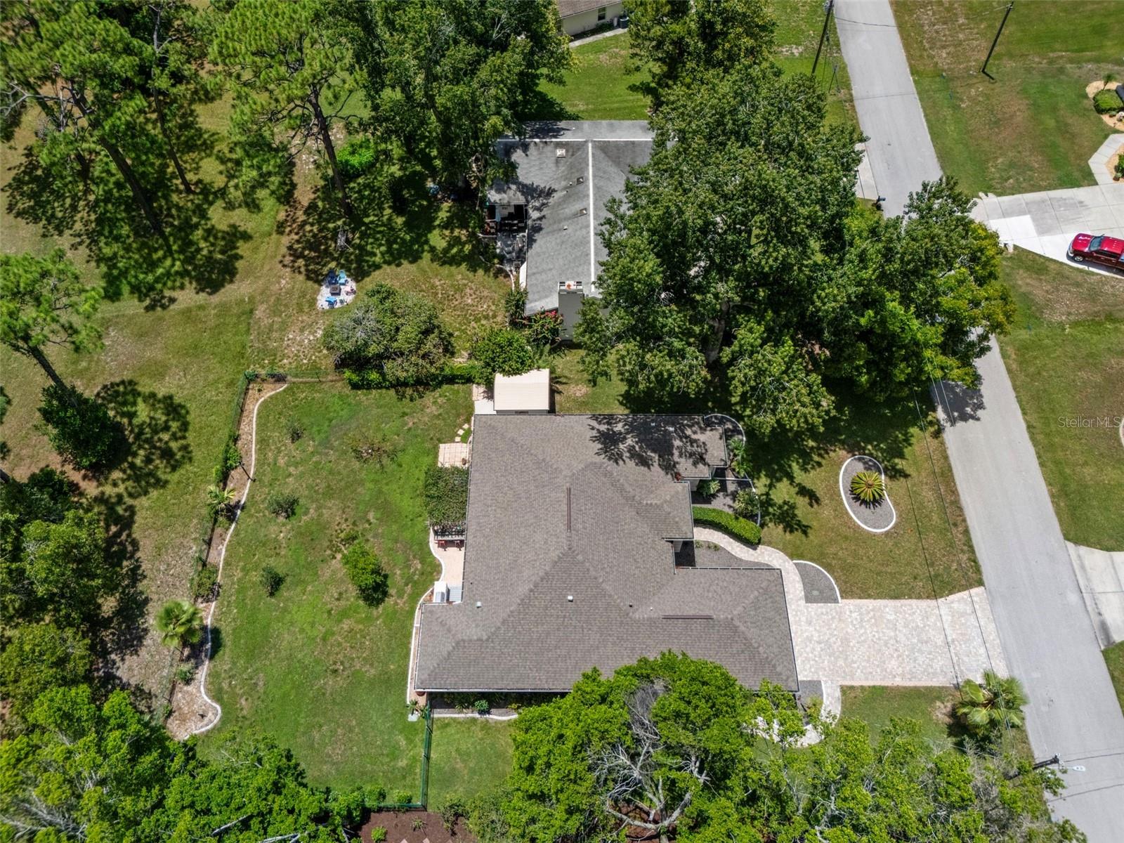 Aerial view of the property from the side shows the spacious yard!
