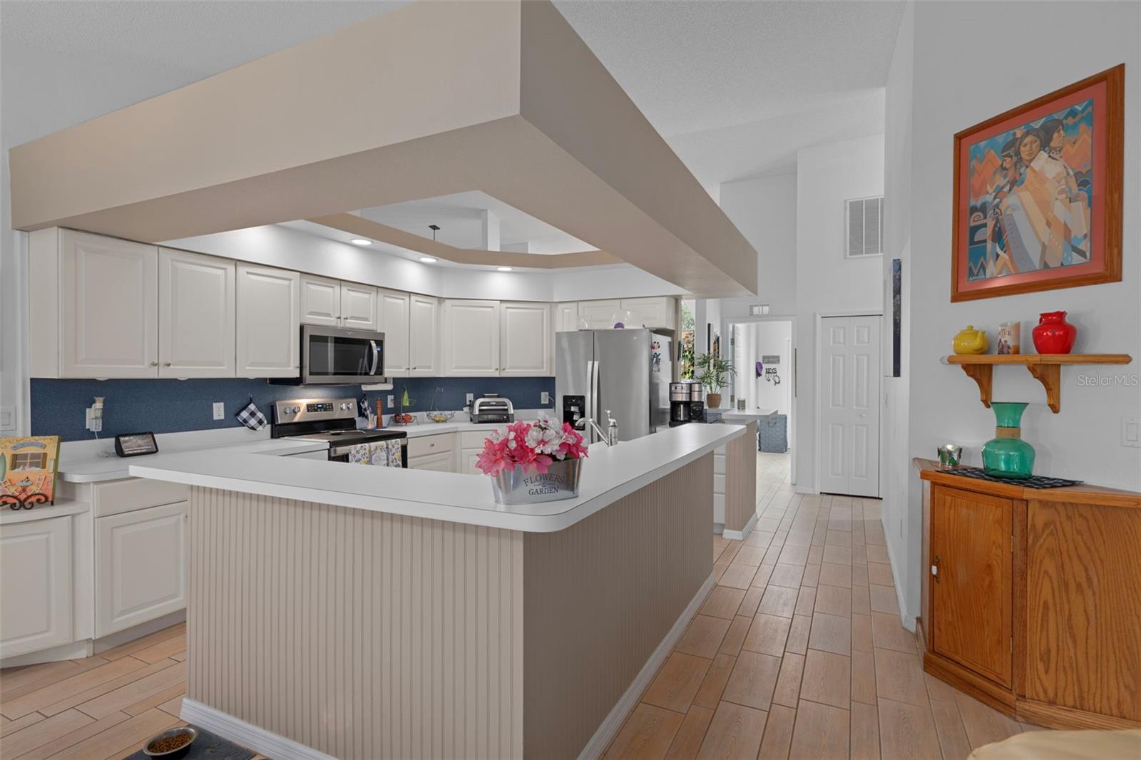 Tray ceilings with recess lighting highlights the kitchen!