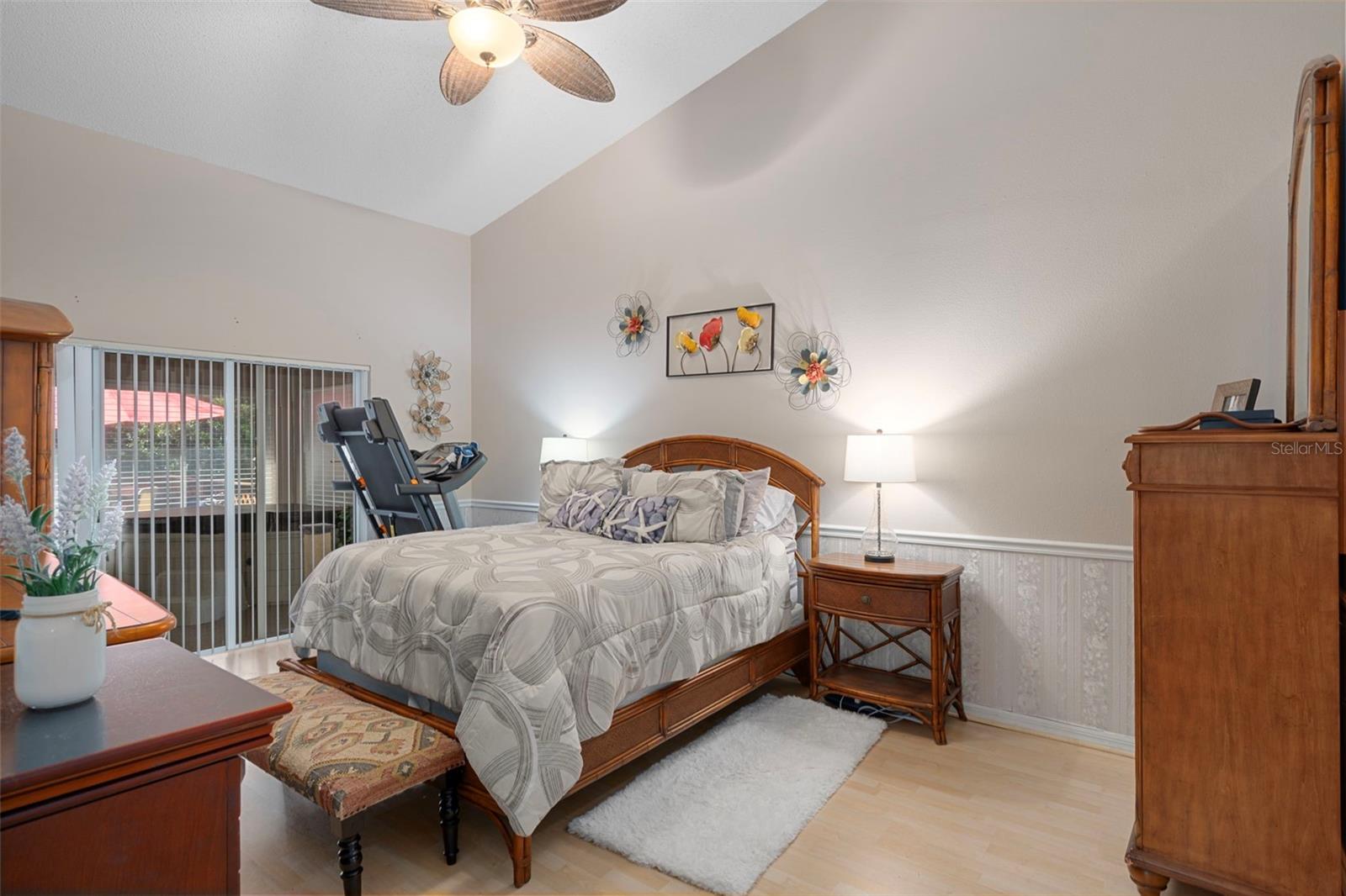 The primary bedroom consists of vaulted ceilings and Florida room access.