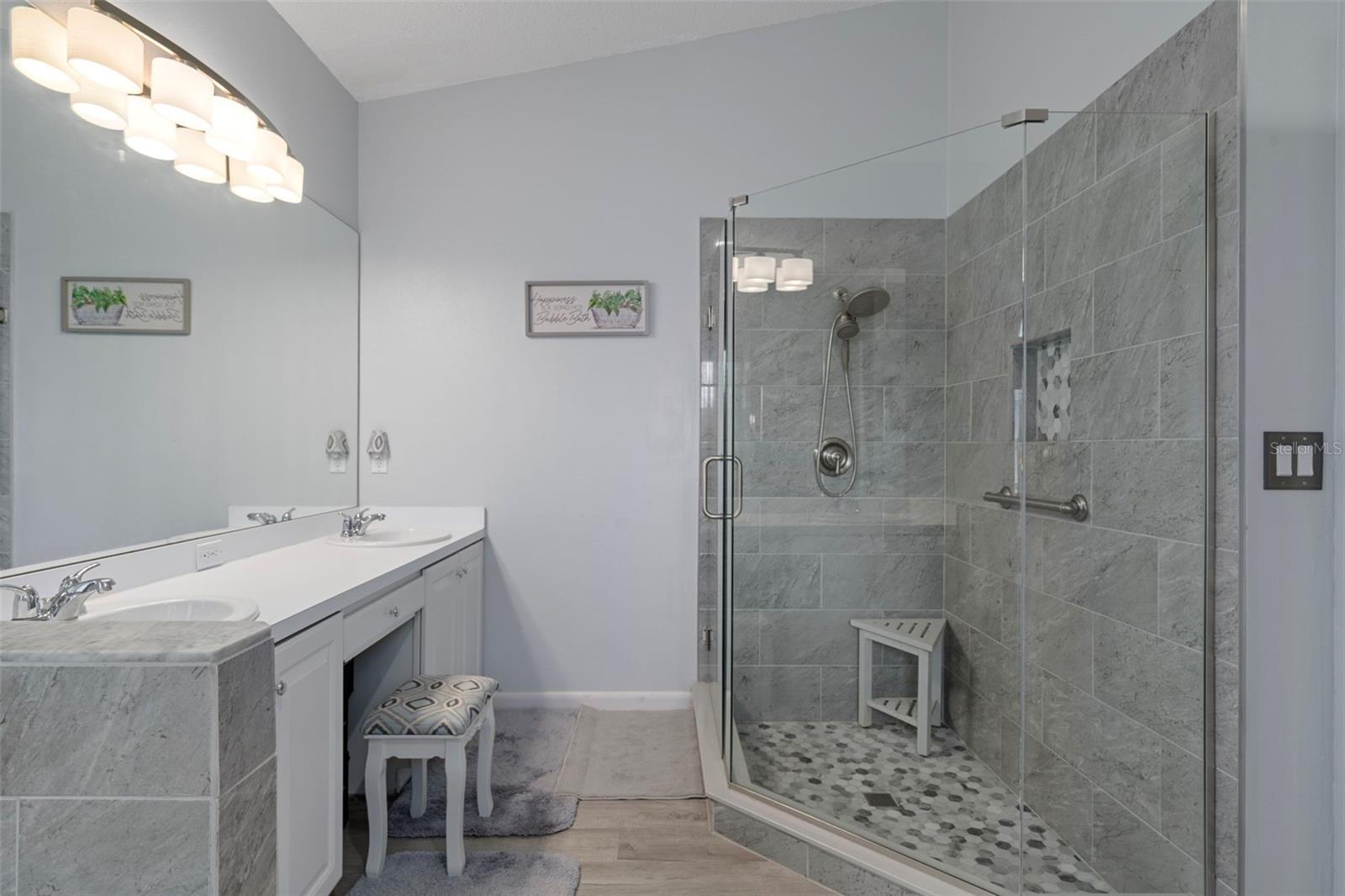Look how gorgeous that custom tiled step in shower is!