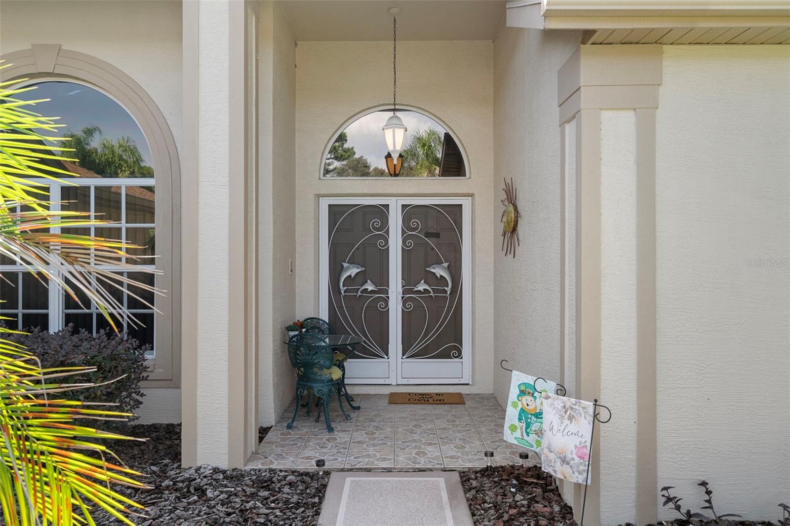 Beautiful double front doors take you into this charming home.
