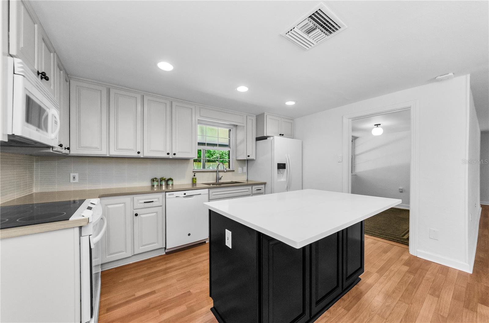 More kitchen with door leading to Florida Room
