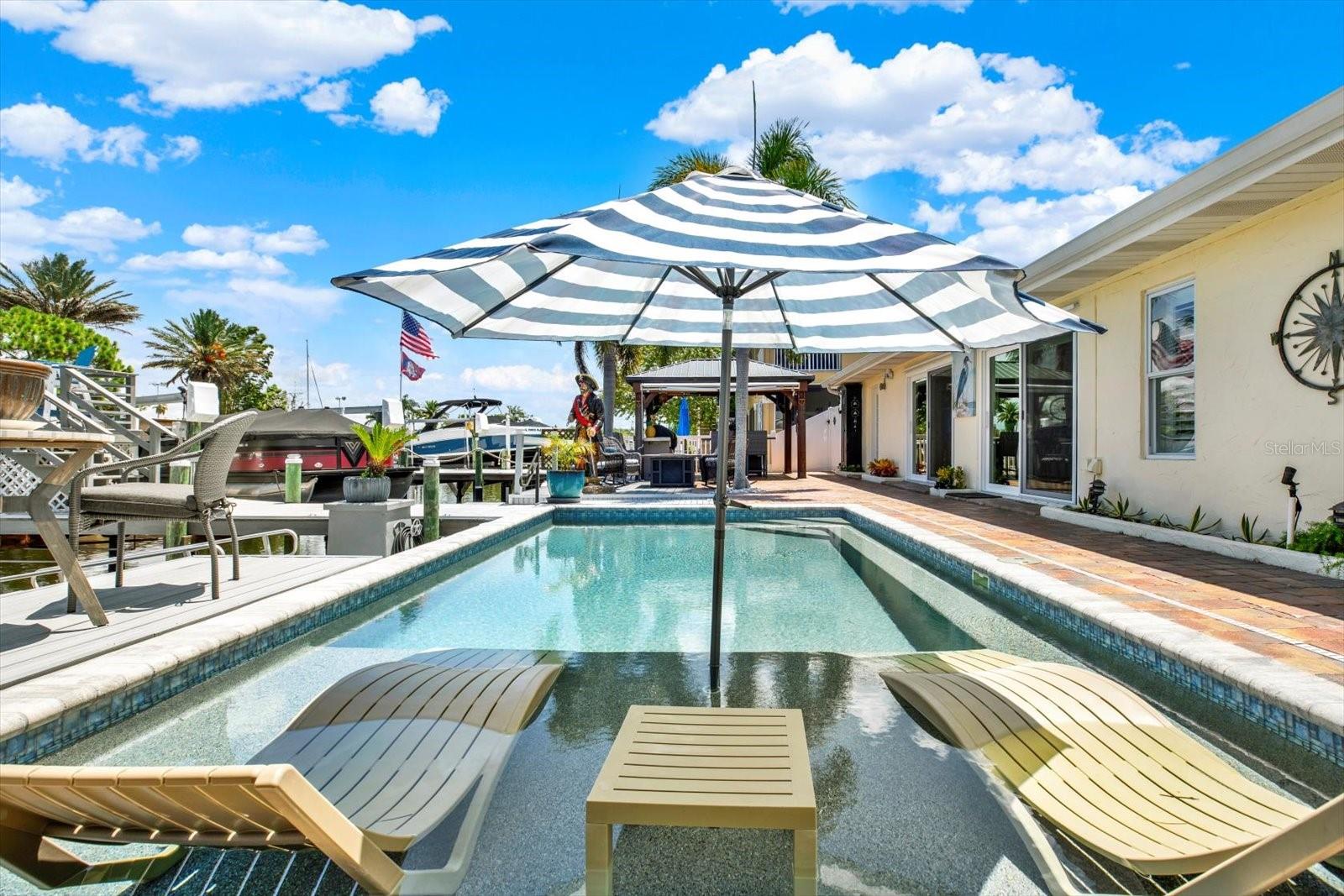Sunbathing pad custom built into this 2023 salt water pool !  Jump In !