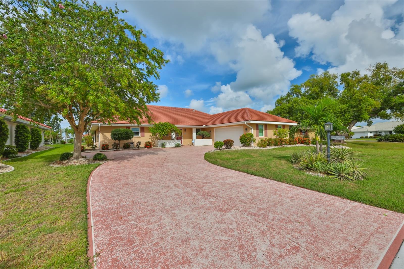 Front left view, tile roof, parking pad (turnaround), 2 car garage - plenty of parking!
