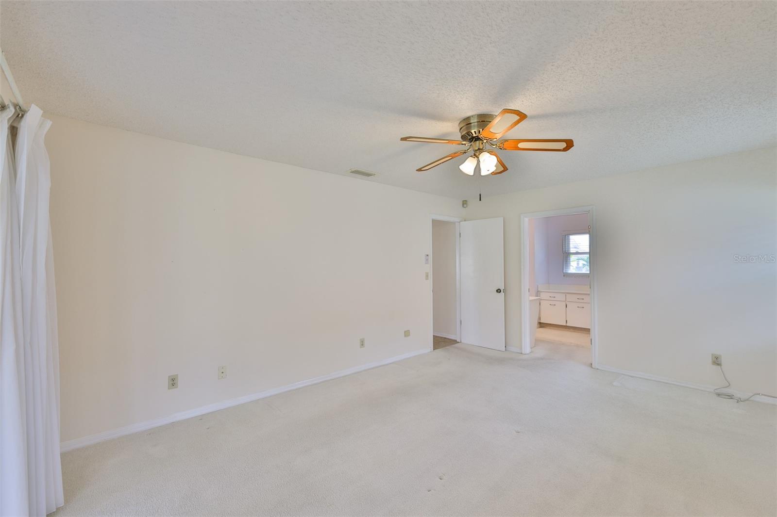 Primary bedroom, left to living room, center to primary bath, walk-in closet and double closet.