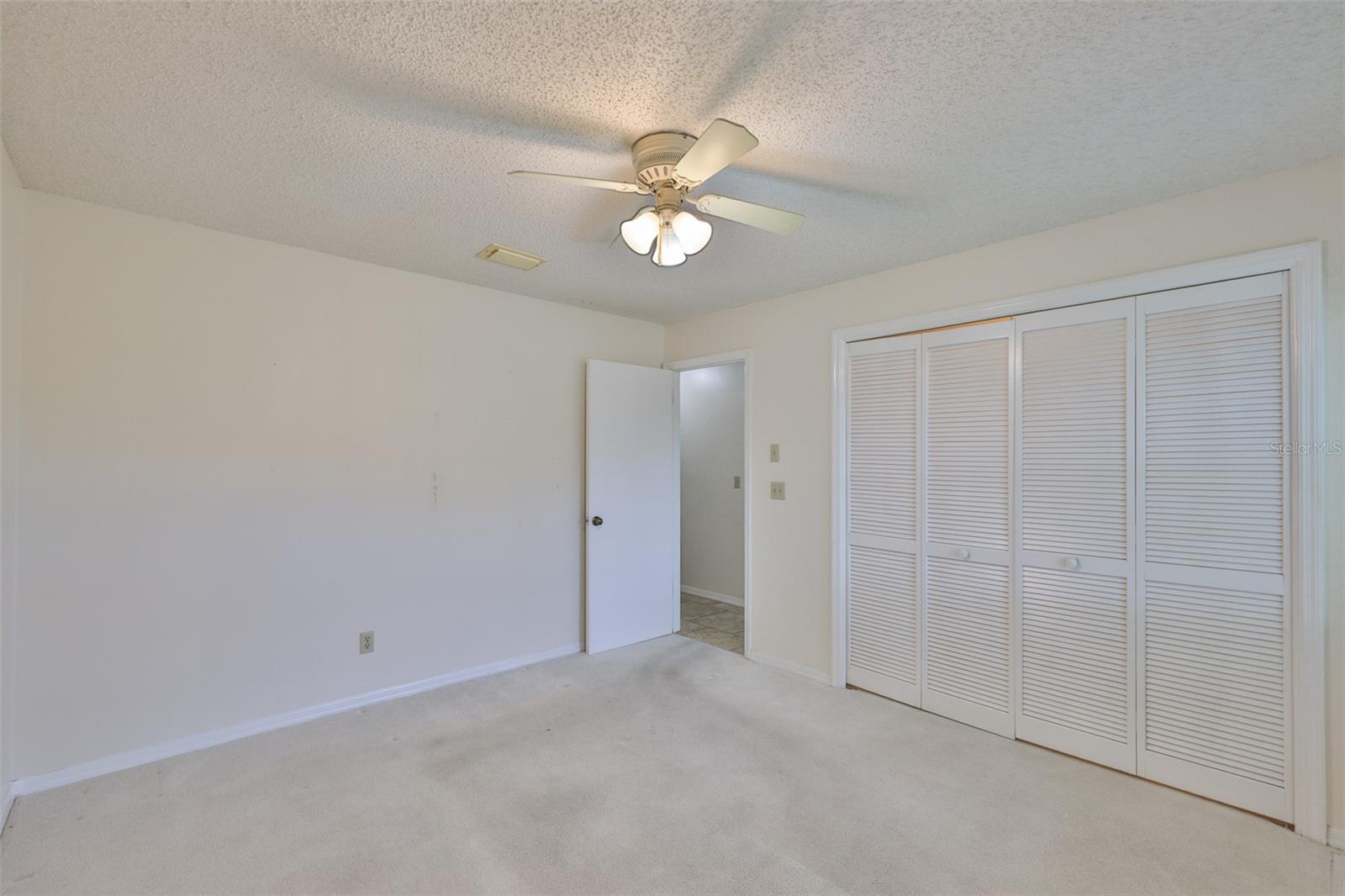 Bedroom 2, exit to hallway and family room. Large closet