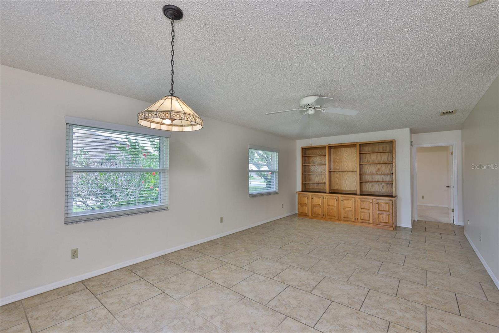 Family room from dinette. Built-in entertainment center, bookcase, display unit.