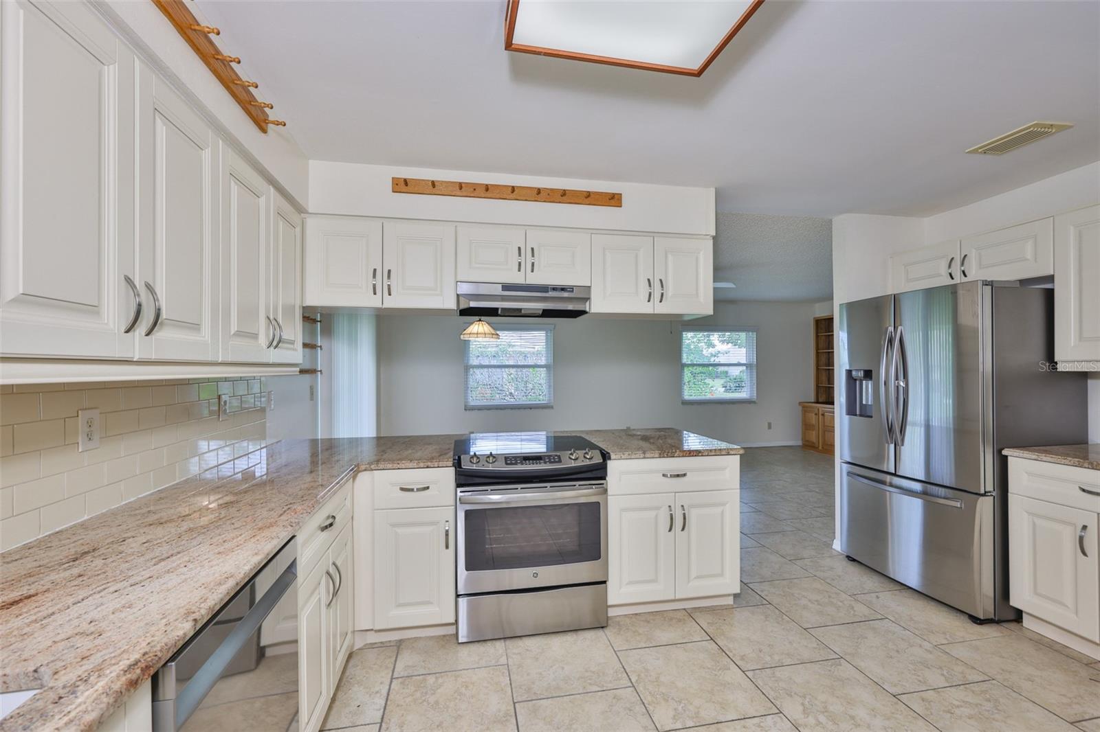 Kitchen, granite counters, stainless appliances, solid wood cabinets, looking to dinette and family room.