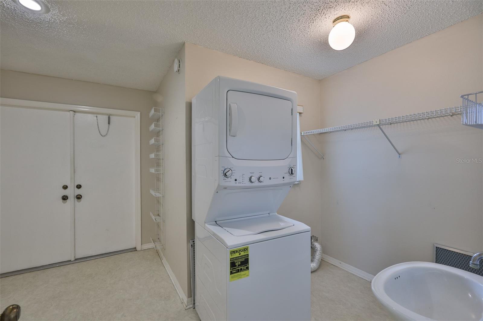 Laundry Room with pedestal sink and golf cart garage.