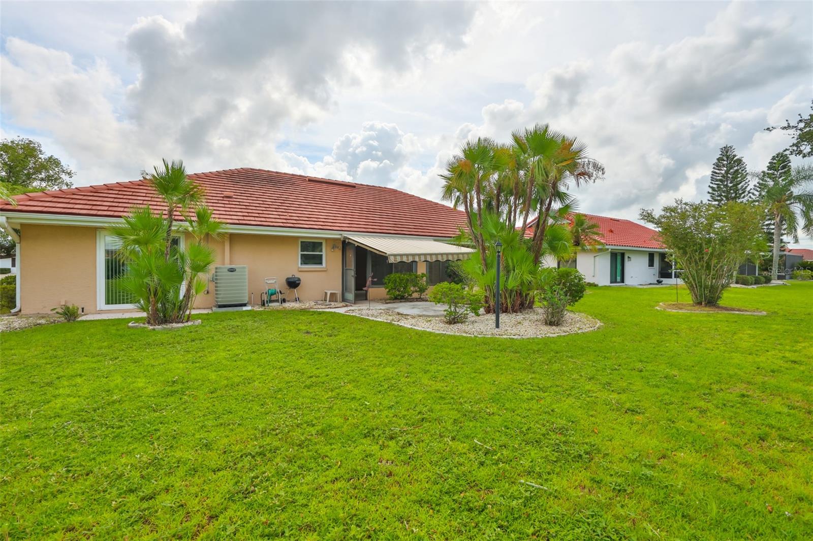 Lawn, garden patio with extended awning, weber bbq grill