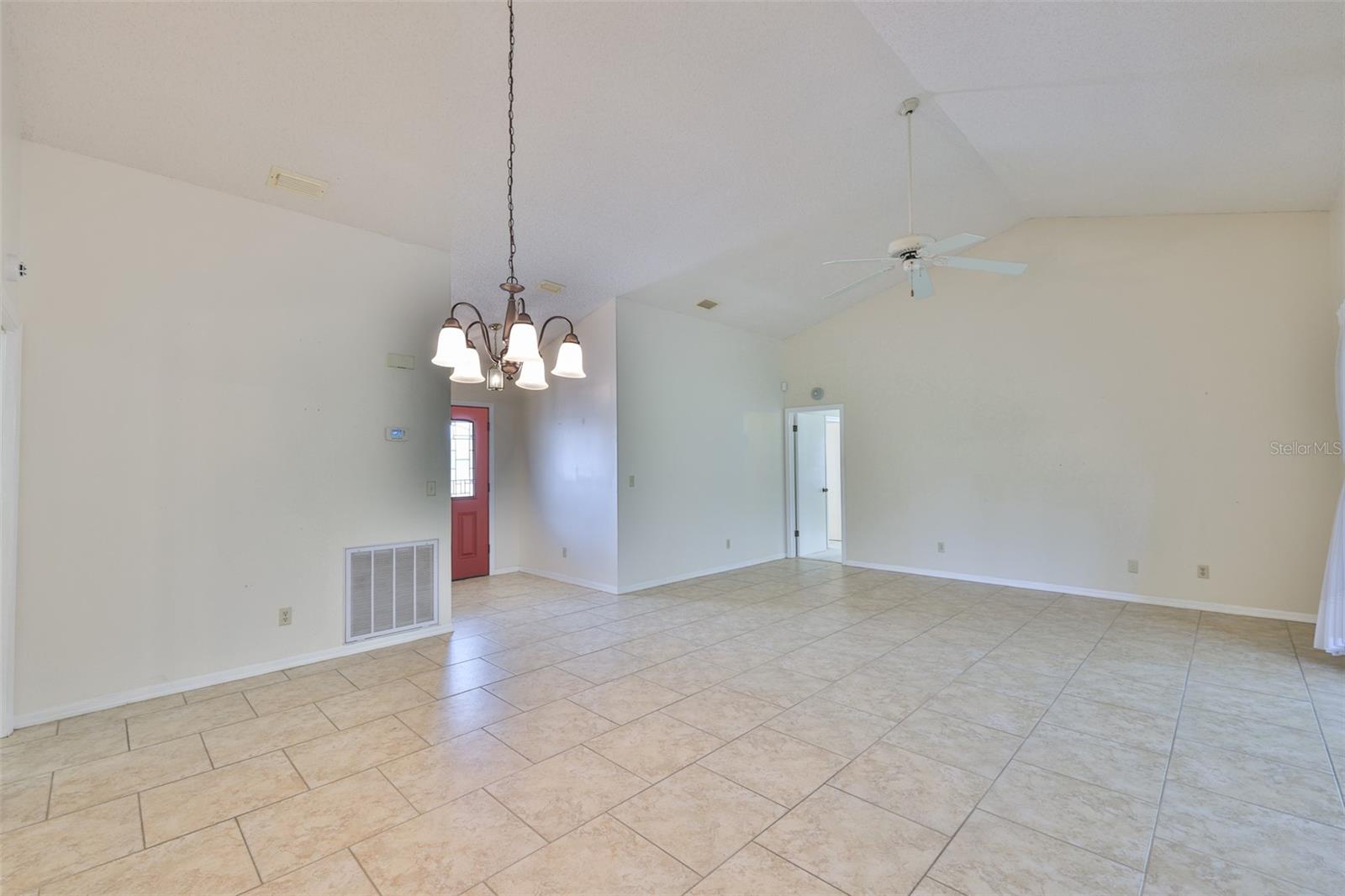 Foyer with leaded glass front door, living room from dining room