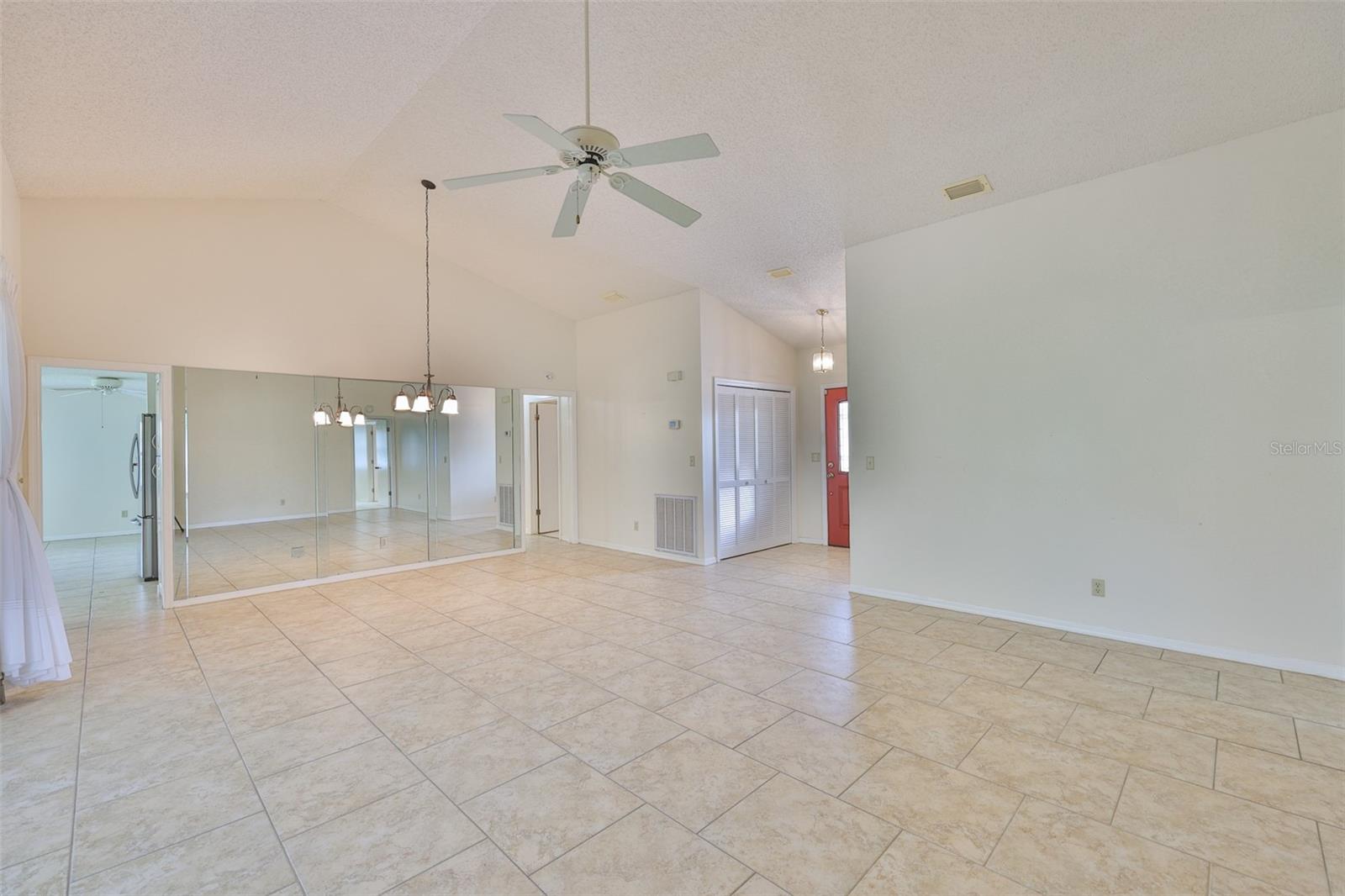 Right center foyer with HVAC, coat closet and leaded glass entry door. Left to kitchen, center to laundry, bath 2 and bedroom 2