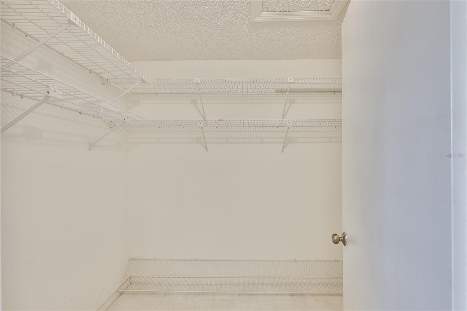Primary bedroom walk-in closet