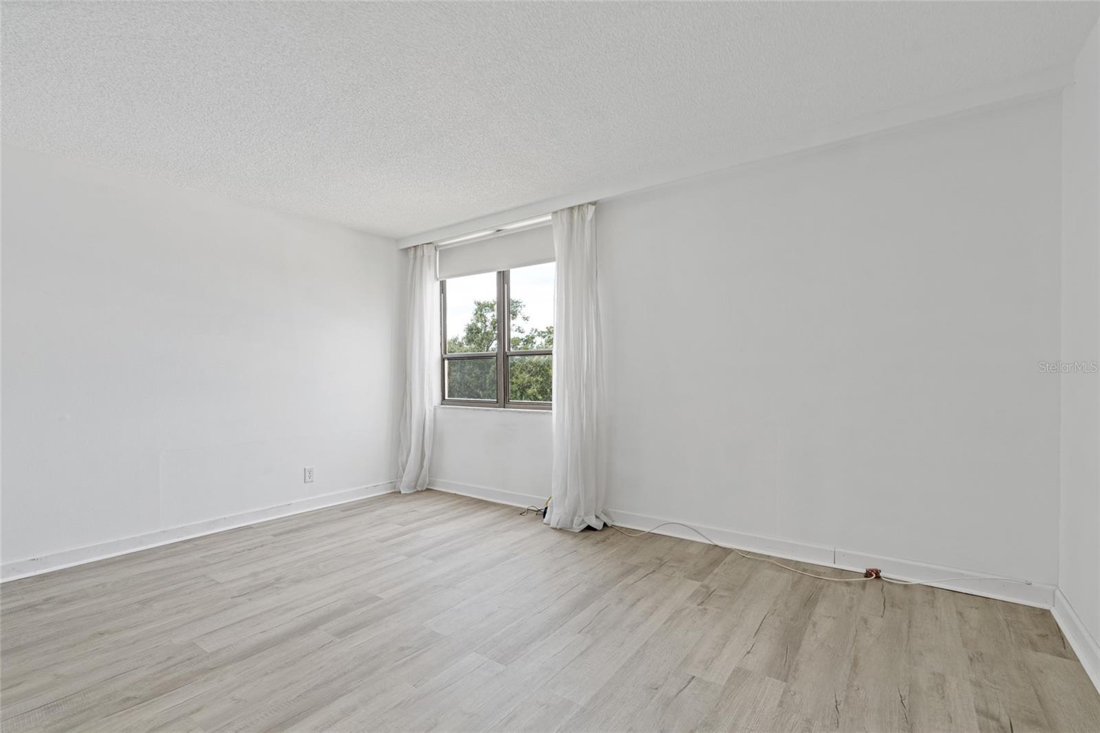 Primary bedroom has a window where you can enjoy viewing the lush scenery.